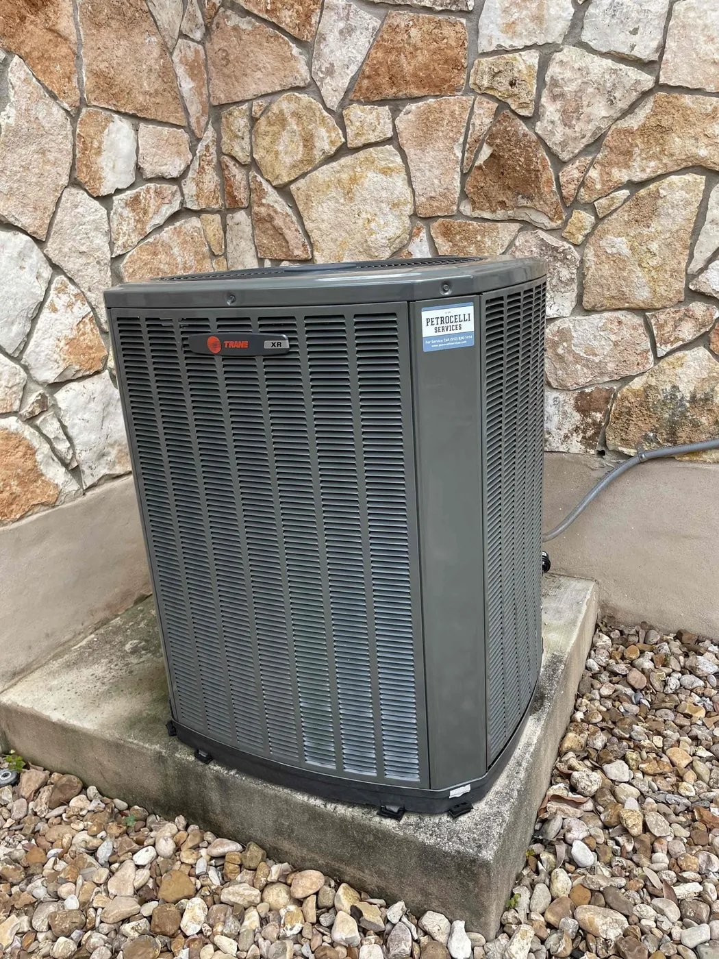 A completed Petrocelli condenser installation at an Austin area home